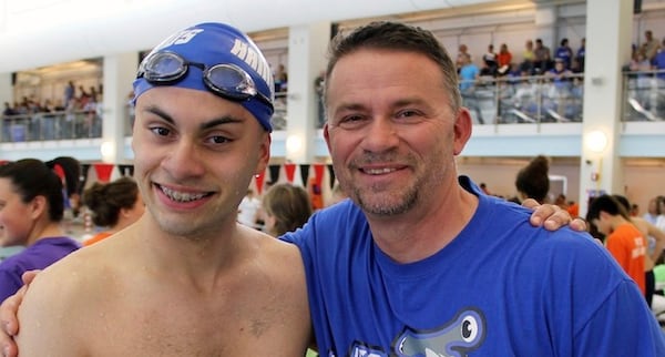 This April 26, 2016, photo provided by Woodland Park Productions, LLC shows Jersey Hammerheads swimmer Michael McQuay and his father and coach, Mike, at a sectional swim meet for the Special Olympics in Neptune, N.J.  (Nicole Chan/Woodland Park Productions, LLC via AP)