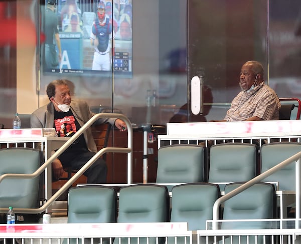 072920 Atlanta: Andy Young (left) and Hank Aaron social distance with masks while watching the Atlanta Braves  home opener on Wednesday, July 29, 2020 in Atlanta.    Curtis Compton ccompton@ajc.com