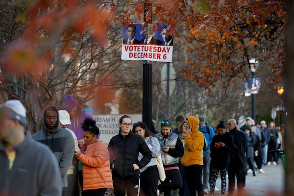 Georgia voters wait to cast their ballots in the U.S. Senate runoff outside a polling location at Ponce De Leon Library in Atlanta on Friday, Dec. 2, 2022. Election Day is Tuesday. (Dustin Chambers/The New York Times)