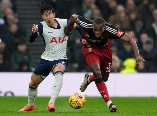 Tottenham Hotspur's Son Heung-Min, left, and Fulham's Issa Diop in action during the English Premier League soccer match at the Tottenham Hotspur Stadium, London, Sunday Dec. 1, 2024. (Ben Whitley/PA via AP)