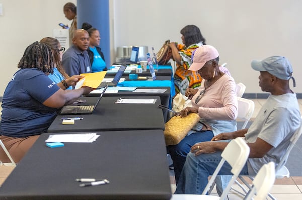 Volunteers help participants during the application assistance session at Atlanta Metro State College on Tuesday, Aug 6, 2024, apply for the anti-displacement tax relief fund program. (Steve Schaefer / AJC) 