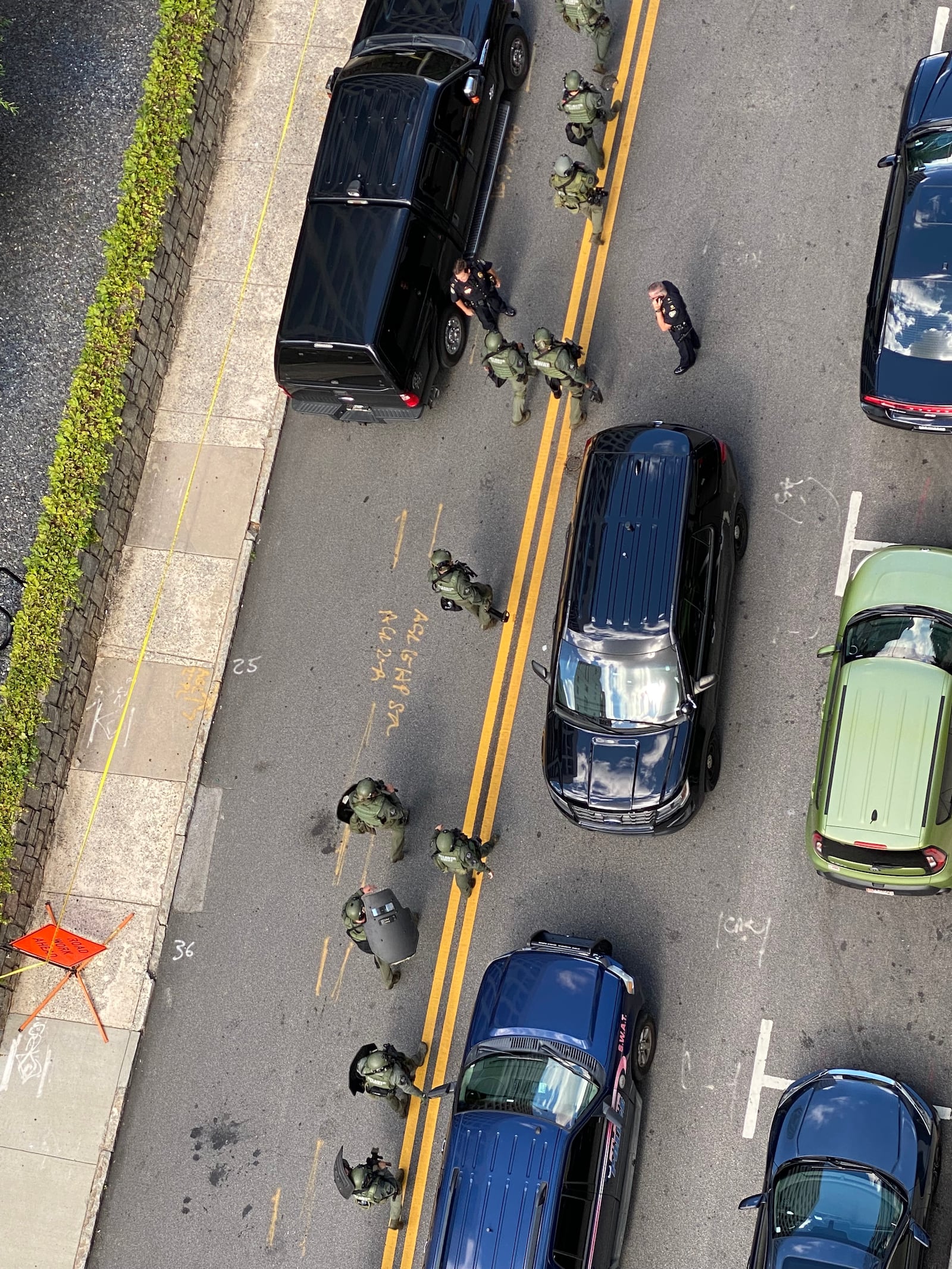 Midtown residents looked on from their apartment windows as police flooded Peachtree Street following the officer's shooting.