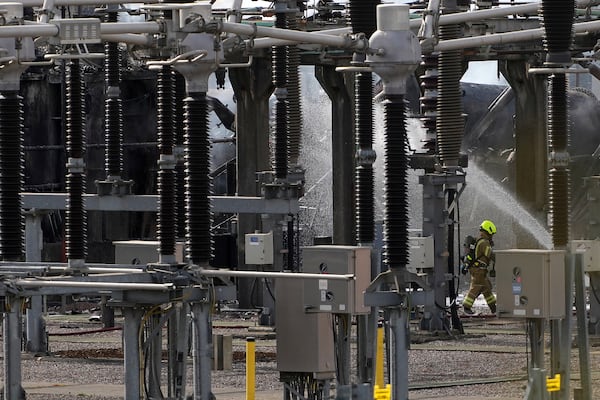 A fireman works at the North Hyde electrical substation, which caught fire last night, leading to the closure of the Heathrow Airport, in London, Friday March 21, 2025..(AP Photo/Kirsty Wigglesworth)