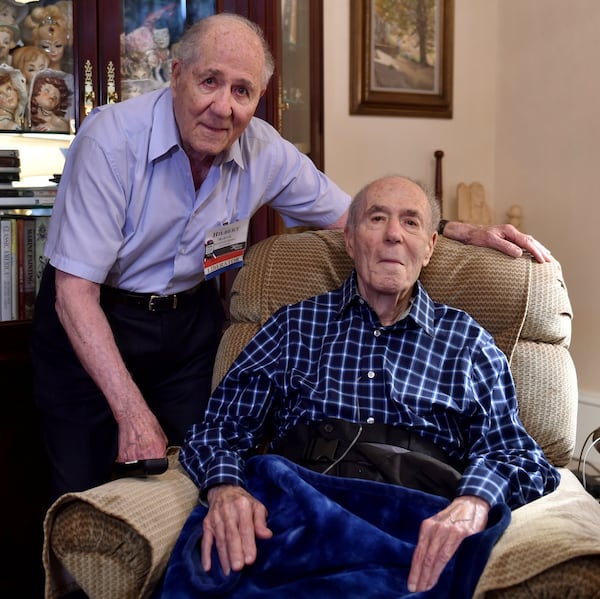 Hilbert Margol, left, and his twin brother, Howard, served together in World War II. Howard Margol died in 2017 at 92. (BRANT SANDERLIN / AJC file photo)