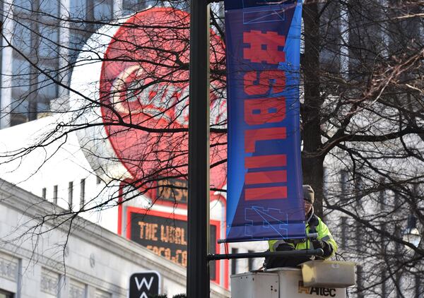 Keith Bentley, contractor, installs Super Bowl LIII banners near Woodruff Park in downtown Atlanta on Wednesday, Jan. 16, 2019. (HYOSUB SHIN / AJC)