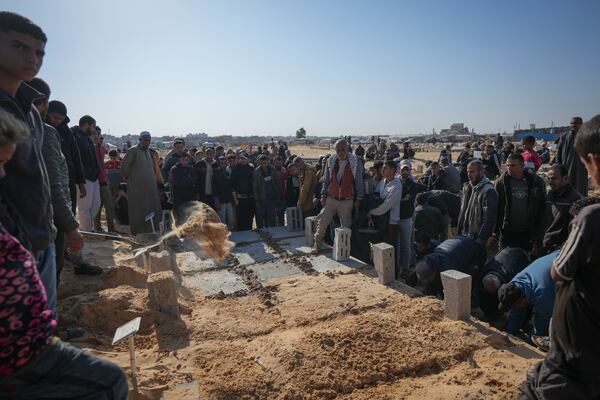 The graves of three children from the same family killed during an Israeli army strike are covered during their burial in Deir al-Balah, Gaza Strip, Thursday Nov. 21, 2024. Seven-year-old Hamza, his five-year-old brother Abdelaziz, and his four-year-old sister Laila Hassan were among 9 people killed by an Israeli strike in Khan Younis on Wednesday. Palestinian health officials say the death toll in the Gaza Strip from the 13-month-old war between Israel and Hamas has surpassed 44,000. (AP Photo/Abdel Kareem Hana)