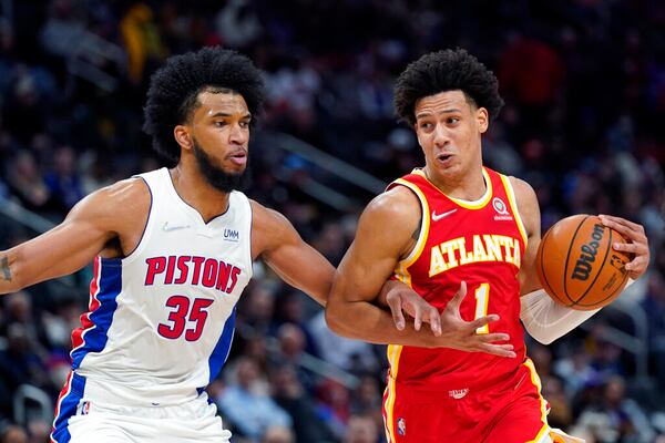 Hawks forward Jalen Johnson (right) is fouled by Detroit Pistons forward Marvin Bagley III (35) Wednesday, March 23, 2022, in Detroit. (AP Photo/Carlos Osorio)