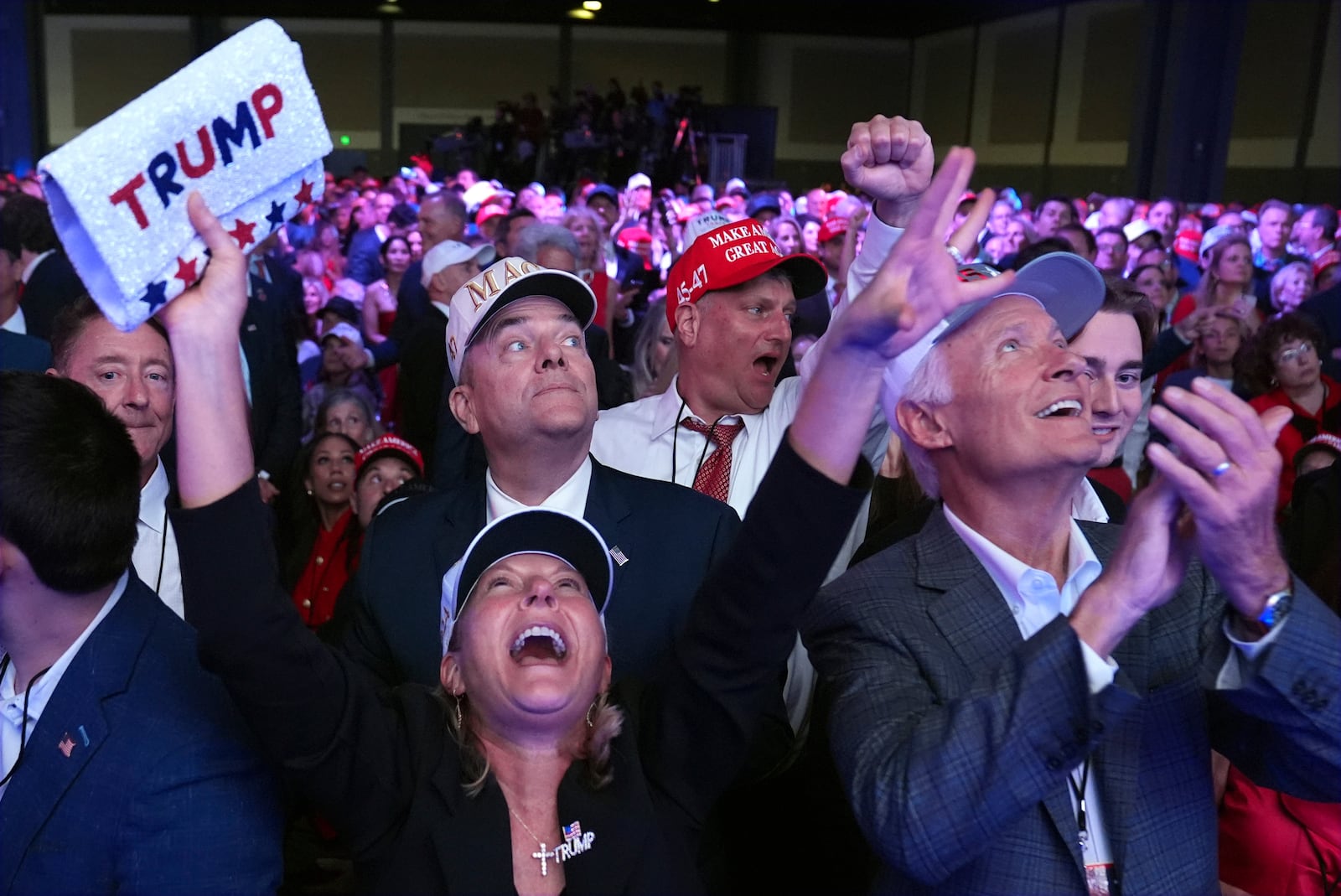 Supporters watch returns at a campaign election night watch party for Republican presidential nominee former President Donald Trump at the Palm Beach Convention Center, Wednesday, Nov. 6, 2024, in West Palm Beach, Fla. (AP Photo/Evan Vucci)