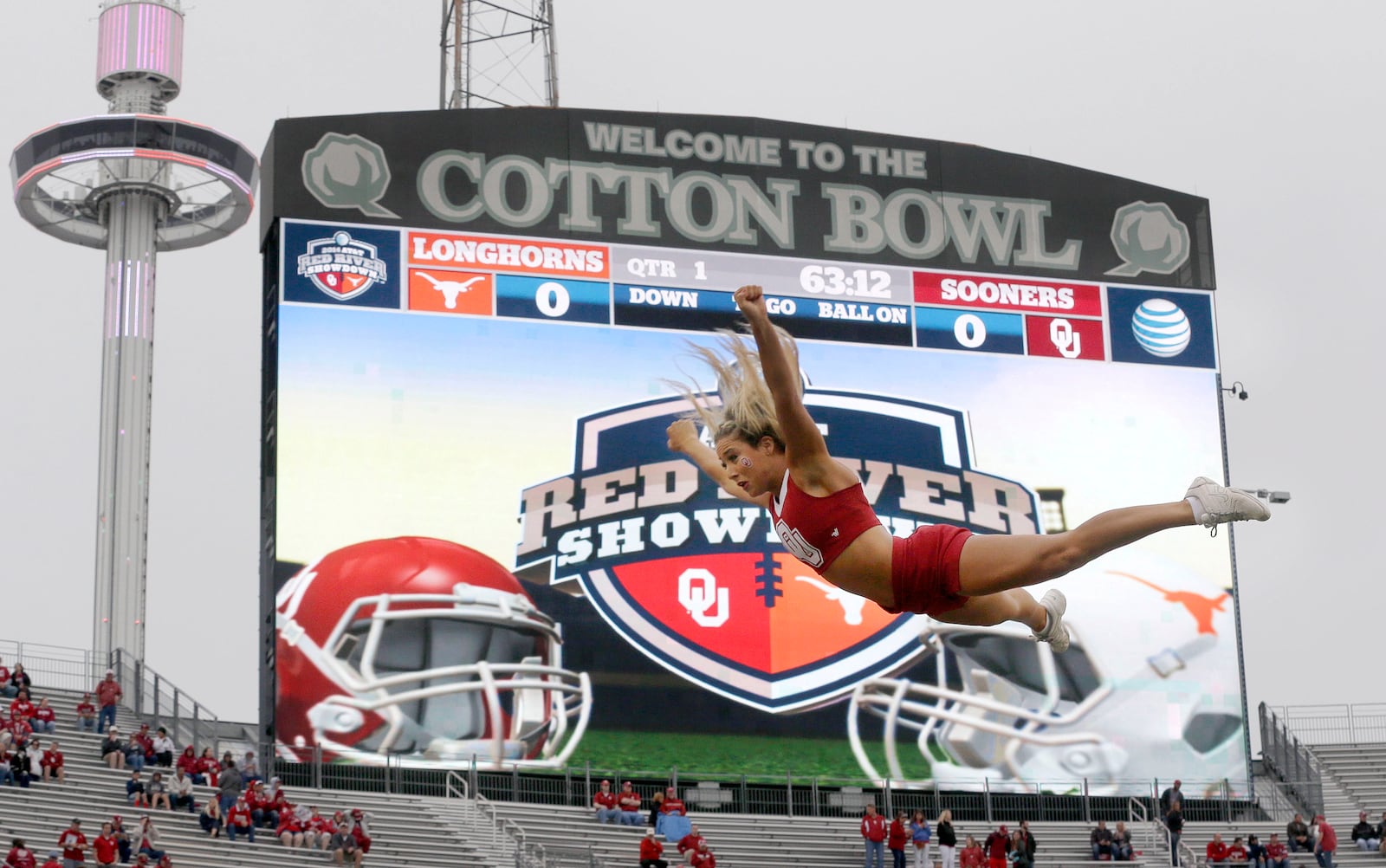 FILE - An Oklahoma cheerleader flies in the air before an NCAA college football game between Texas and Oklahoma at the Cotton Bowl, Saturday, Oct. 11, 2014, in Dallas. (AP Photo/LM Otero, File)