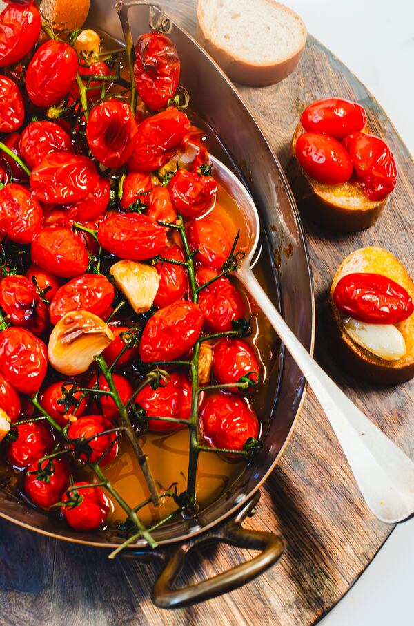 You can serve Slow Roasted Cherry Tomato Confit hot, warm or room temperature over bread, as well as pasta, vegetables or meat. (Virginia Willis for The Atlanta Journal-Constitution)