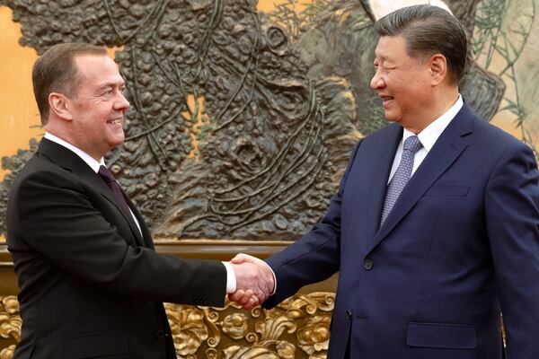 Russian Security Council Deputy Chairman and the head of the United Russia party Dmitry Medvedev, left, and Chinese President Xi Jinping shake hands during their meeting in Beijing, China, Thursday, Dec. 12, 2024. (Ekaterina Shtukina, Sputnik Pool Photo via AP)