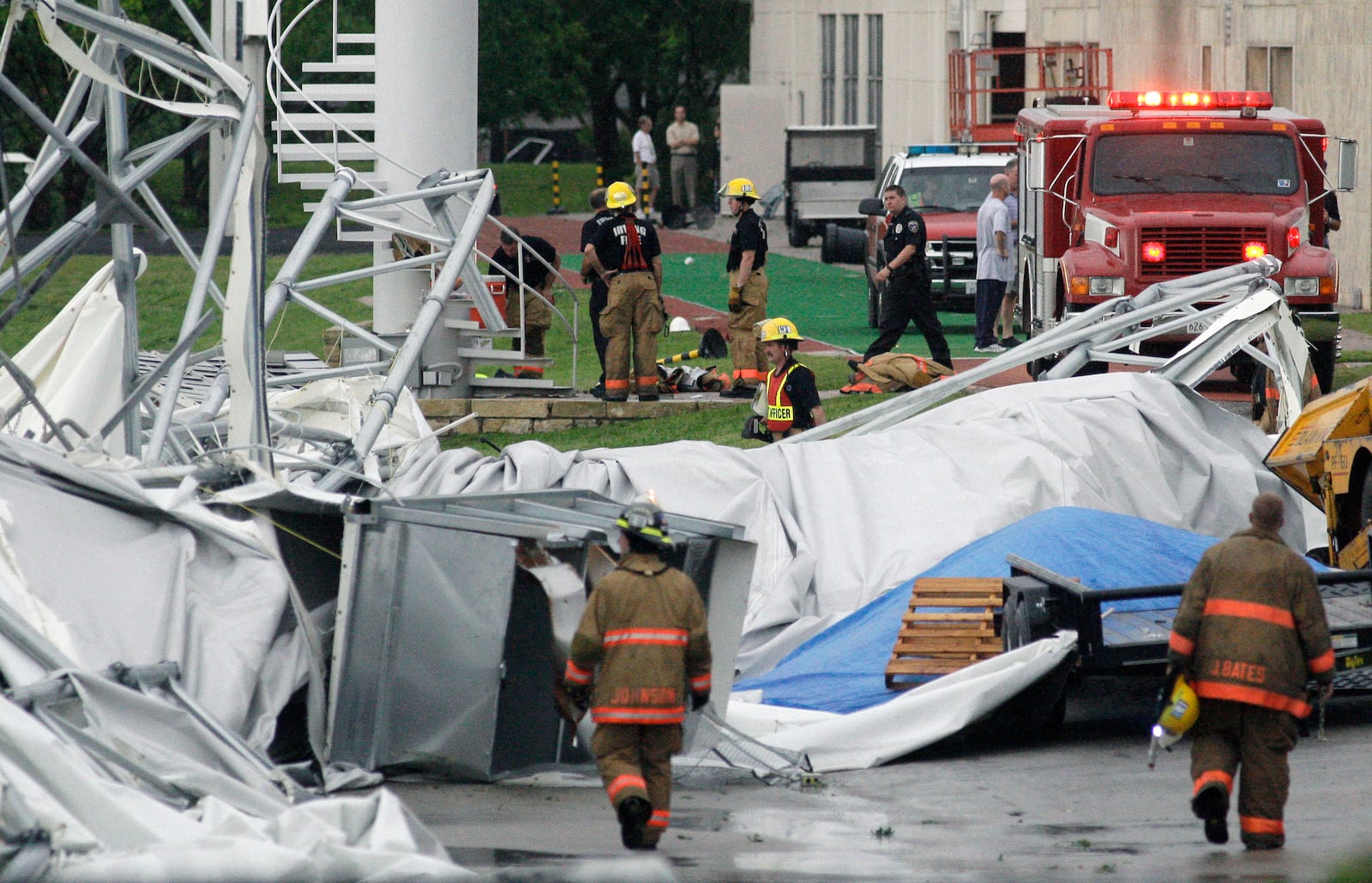 FILE - Firefighters investigate the collapsed canopy that covered the Dallas Cowboys indoor football facility in Irving, Texas, May 2, 2009. (AP Photo/File)