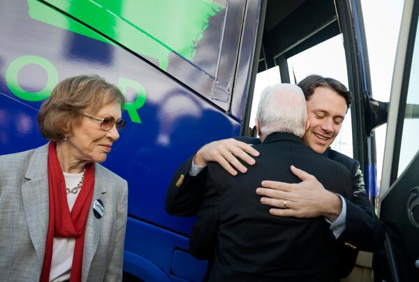 Jason Carter, right, embraces his grandfather, former President Jimmy Carter, as former first lady Rosalynn Carter, left, looks on in Columbus, Ga., in 2014. (AP Photo/David Goldman)