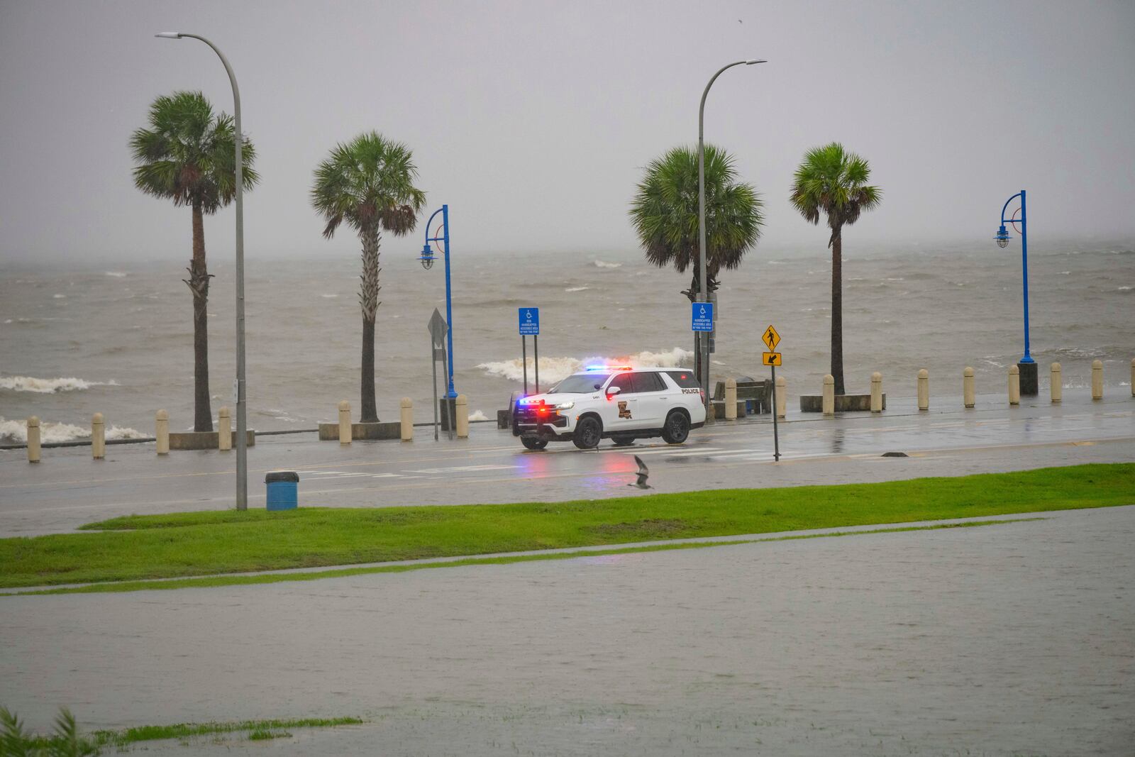 Orleans Levee District Police patrol Lakeshore Drive along Lake Ponchartrain as wind and rain pick up from Hurricane Francine in New Orleans, Wednesday, Sept. 11, 2024. (AP Photo/Matthew Hinton)