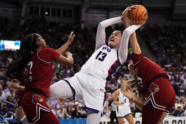 TCU's Sedona Prince (13) is fouled taking a shot by Louisville's Isla Juffermans, right, as Nyla Harris (2) helps defend in the second half in the second round of the NCAA college basketball tournament in Fort Worth, Texas, Sunday, March 23, 2025. (AP Photo/Tony Gutierrez)