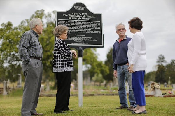 New Hope Memorial Flight 242 board members Loran Wills (from left), Peggy Wills, Hugh Walters and Cherry Waddell at the site of the current marker memorializing the crash. BOB ANDRES / BANDRES@AJC.COM