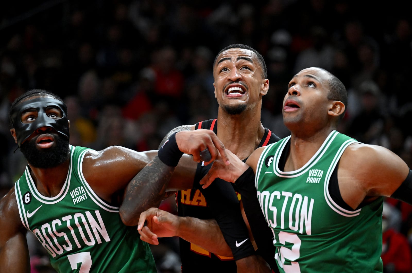 Atlanta Hawks' forward John Collins (20) fights for position against Boston Celtics' guard Jaylen Brown (7) and center Al Horford (42). (Hyosub Shin / Hyosub.Shin@ajc.com)