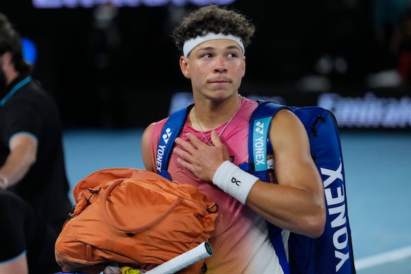 Ben Shelton of the U.S. gestures as he leaves Rod Laver Arena following his semifinal match against Jannik Sinner of Italy at the Australian Open tennis championship in Melbourne, Australia, Friday, Jan. 24, 2025. (AP Photo/Vincent Thian)