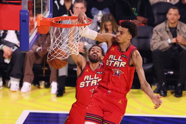 The Hawks' Trae Young (background) was very excited to witness All-Star teammate Victor Wembanyama's dunk.