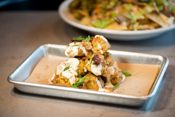  House-Made Loaded Tots with bacon, chives, and Gouda cheese sauce. Photo credit- Mia Yakel.