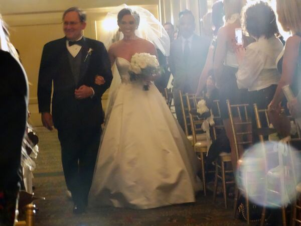 Amanda Bakalar walks down the aisle with her father Steve.