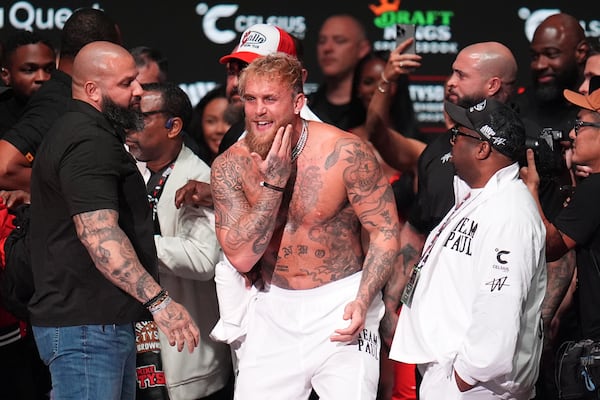 Jake Paul reacts after being slapped by Mike Tyson during a weigh-in ahead of their heavyweight bout, Thursday, Nov. 14, 2024, in Irving, Texas. (AP Photo/Julio Cortez)