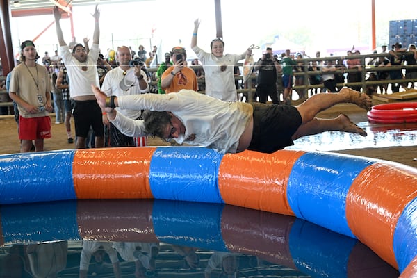 Tom Vars jumps into a pool of water after losing in the Human Beer Pong competition during the Florida Man Games, Saturday, March 1, 2025, in Elkton, Fla. (AP Photo/Phelan M. Ebenhack)