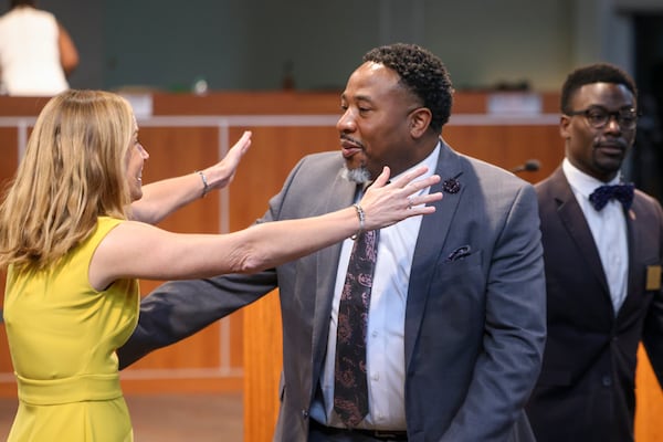 Devon Horton gets a hug from DeKalb County school board member Allyson Gevertz after the board hired him for the superintendent position at the DeKalb County Administrative Center, Wednesday, April 19, 2023, in Stone Mountain, Ga. (Jason Getz / Jason.Getz@ajc.com)
