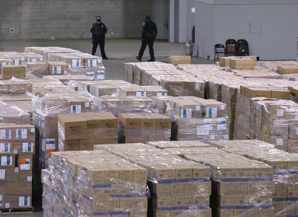 Security guards watch over 4000 pallets of protective equipment at the alternative hospital bed capacity facility the state of Georgia is re-activating at the Georgia World Congress Center that also houses the recent PPE shipments for the state on Tuesday, Dec. 29, 2020, in Atlanta.  Curtis Compton / Curtis.Compton@ajc.com