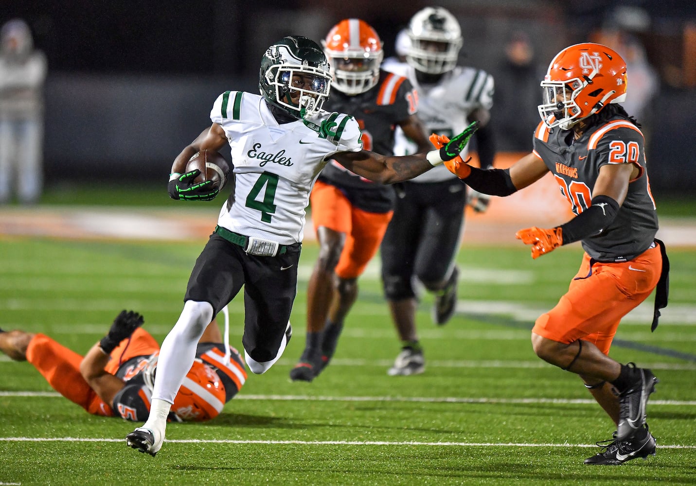 Collins Hill’s Chase Nash stiff arms North Cobb’s James Roe (24) during the first half of play Friday, Nov. 10, 2023 at North Cobb High School. (Daniel Varnado/For the AJC)