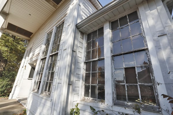 An abandoned building inside Fort McPherson, with broken windows and peeling paint. Outside the fences of Tyler Perry studio, the rest of the former Fort McPherson appears neglected. Nearby neighborhoods are on the upswing, with speculators buying houses. The civilian authority that owns about 130 acres of the former post recently announced it would pay its developer millions of dollars not to develop and will have to find a new real estate partner. Atlanta Mayor Keisha Lance Bottoms’ office says the authority owes the city about $5 million and has threatened a lawsuit. BOB ANDRES / ROBERT.ANDRES@AJC.COM