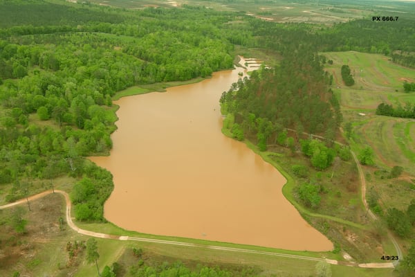 An aerial photo captured on April 9, 2023, shows a lake on the property of Shaun and Amie Harris in Stewart County turned red by sediment runoff. (Courtesy of Shaun Harris)