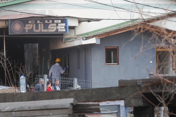 A firefighter inspects a nightclub after a massive fire in the town of Kocani, North Macedonia, Sunday, March 16, 2025. (AP Photo/Boris Grdanoski)