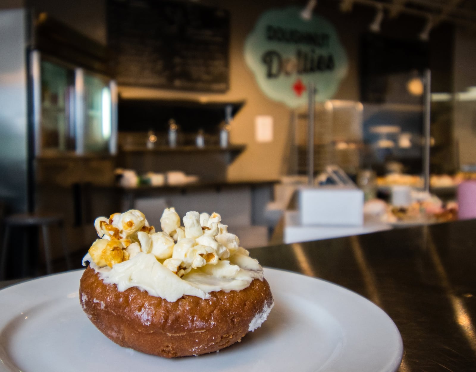 The Buttered Popcorn doughnut, at Doughnut Dollies near downtown Marietta, is a nod to Oscar season. CONTRIBUTED BY HENRI HOLLIS