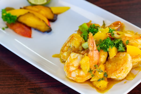 Dat Fire Jerk Chicken's irie mango shrimp dish makes use of jerk seasoning. Ryan Fleisher for The Atlanta Journal-Constitution