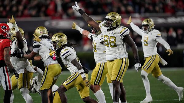 Georgia Tech defense celebrate a fumble by Georgia wide receiver Dominic Lovett (6) during the first half of an NCAA college football game, Friday, Nov. 29, 2024, in Athens, Ga. (AP Photo/Mike Stewart)