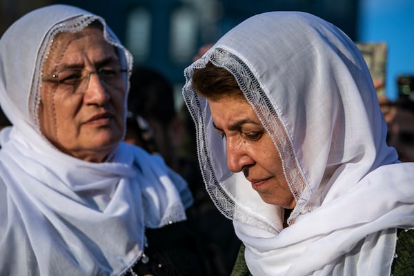 Kurdish women gather to watch live on a tv screen a Pro-Kurdish Peoples' Equality and Democracy Party, or DEM, delegation members releasing an statement from the jailed leader of the rebel Kurdistan Workers' Party, or PKK, Abdullah Ocalan, in Diyarbakir, Turkey, Thursday, Feb. 27, 2025. (AP Photo/Metin Yoksu)