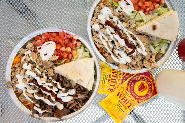 Beef gyro platter (left) and chicken platter (right) with toppings, special white sauce, and hot sauce at the Halal Guys. CONTRIBUTED BY MIA YAKEL