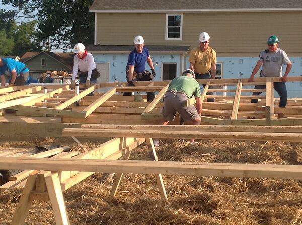 In the summer of 2016 the Carter project moved to Memphis, Tenn., where former president Jimmy Carter (left, white shirt) and country superstar Garth Brooks (gold shirt) help raise a wall on the first day of a weeklong Habitat for Humanity build. Jill Vejnoska/Jill.Vejnoska@ajc.com