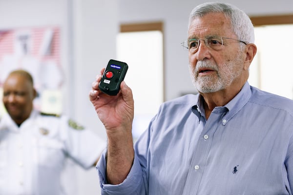 Isaac Newton, President of Black Creek Integrated Systems, holds up a tracker on Tuesday, May 31, 2022.  The tracker will be connected to the new medical tracking devices that will be worn by all Cobb County inmates. (Natrice Miller / natrice.miller@ajc.com)

