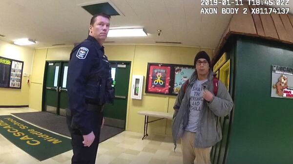 Body camera footage shot by Eugene, Oregon, police Officer Steve Timm shows Charles Landeros, 30, talking to Officer Aaron Johns, at left, moments before Landeros was shot and killed Jan. 11, 2019, outside Cascade Middle School, in front of his 12-year-old daughter. Timm and Johns intervened in a custody dispute stemming from Landeros enrolling the girl in the school the day before without her mother's permission. The footage shows Landeros pull a 9 mm handgun on the officers just before he was killed.