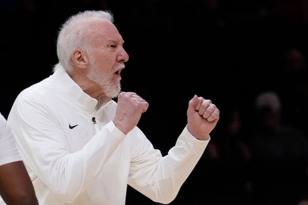 San Antonio Spurs head coach Gregg Popovich calls out to players during the first half of an NBA preseason basketball game against the Miami Heat, Tuesday, Oct. 15, 2024, in Miami. (AP Photo/Wilfredo Lee)