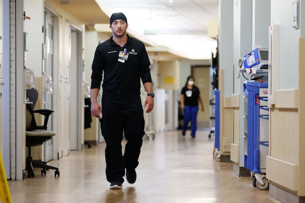 The registered nurse at Northeast Georgia Medical Center, Dylan Glass, walks between rooms with COVID-19 patients; the unit has sixteen beds occupied by COVID-19 patients, but the hospital administrators mentioned that they have seen a significant reduction in cases.
Miguel Martinez /miguel.martinezjimenez@ajc.com