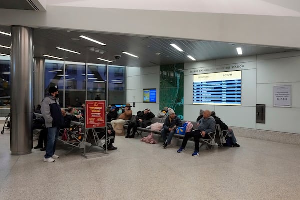 Commuters wait inside the George Washington Bridge Bus Station in New York, Friday, Dec. 6, 2024, where the gunman fleeing Wednesday's shooting of UnitedHealthcare CEO Brian Thompson took a taxi to, according to surveillance video. (AP Photo/Richard Drew)