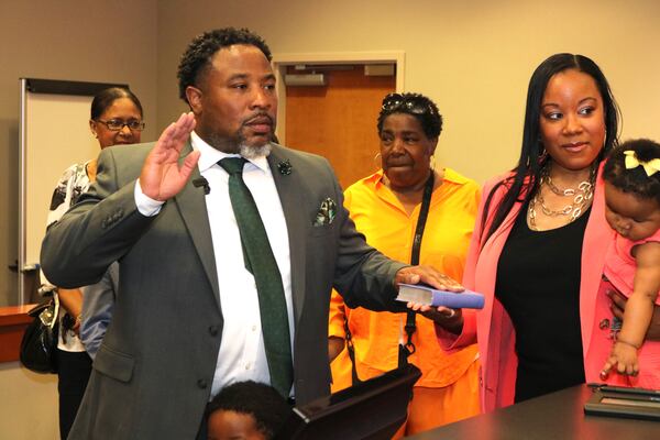 Devon Horton takes the oath of office at the DeKalb County Superior Courthouse in Decatur on Thursday, June 29, 2023. Members of his family, including his wife, Christiane Horton, were in attendance at the private ceremony. On July 1, 2023, Horton began working as the superintendent of the DeKalb County School District. (Courtesy of DeKalb County School District)