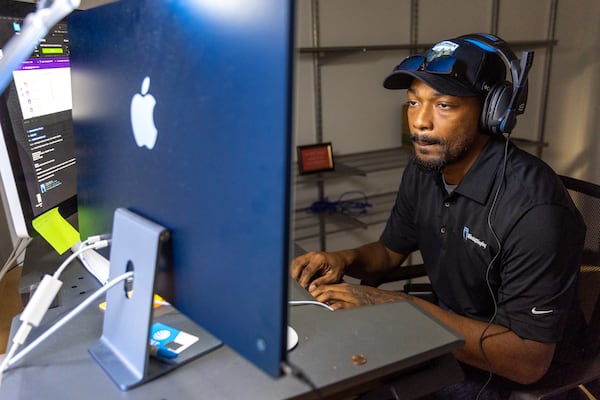 Terrance Bennett, support technician at  Kiosk & Display, works at the company’s office in Peachtree Center in Atlanta on Monday, September 25, 2023. (Arvin Temkar / arvin.temkar@ajc.com)