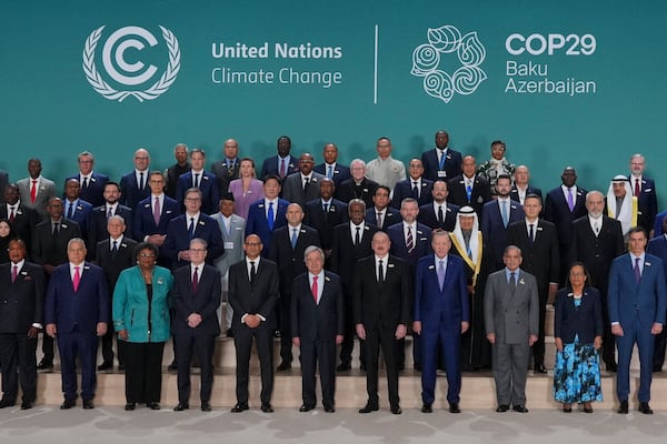 Barbados Prime Minister Mia Mottley, United Kingdom Prime Minister Keir Starmer, Simon Stiell, United Nations climate chief, Antonio Guterres, United Nations secretary-general, Ilham Aliyev, Azerbaijan president, and Turkey President Recep Tayyip, front center, pose with others for a group photo at the COP29 U.N. Climate Summit, Tuesday, Nov. 12, 2024, in Baku, Azerbaijan. (AP Photo/Peter Dejong)