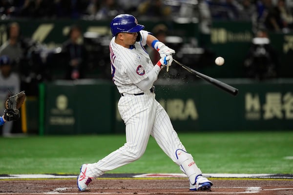 Chicago Cubs' Seiya Suzuki breaks his bat on a ground out in the first inning of an MLB Japan Series baseball game against the Los Angeles Dodgers in Tokyo, Japan, Tuesday, March 18, 2025. (AP Photo/Hiro Komae)