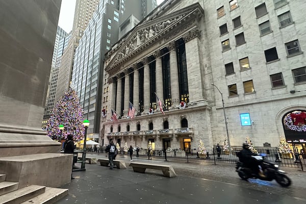 A scooter passes the New York Stock Exchange in New York's Financial District on Tuesday, Dec. 17, 2024. (AP Photo/Peter Morgan)