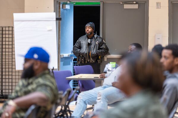 An Atlanta police officer listens in during a Violence Prevention Forum at Kipp Atlanta Collegiate in Atlanta on Friday.